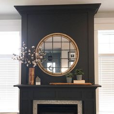 a living room with a fire place and a mirror on the fireplace mantels