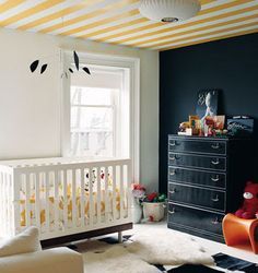 two pictures of a baby's room with yellow and black furniture, zebra rugs on the floor