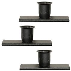 three black pots are sitting on the shelf