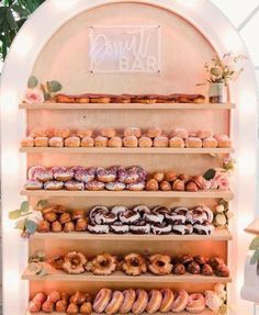 a display case filled with lots of different types of doughnuts and pastries