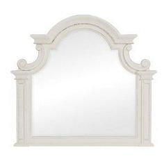 a white mirror with an arch shaped frame