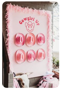 a cowgirl themed birthday party with pink icing and cupcakes on the wall