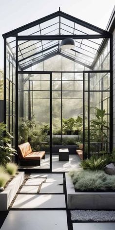 the inside of a greenhouse with lots of plants and furniture in it's center