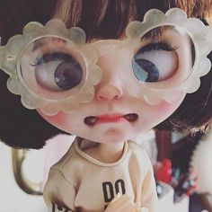 a close up of a doll with big eyes