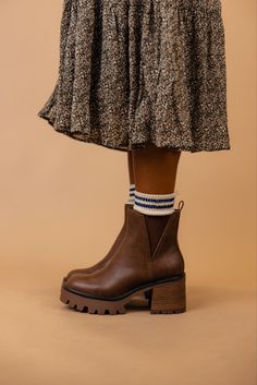 The Rusty is a dark brown bootie featuring a 3" heel and a small platform. Take inspo from our pictures and pair with your favorite boot socks and a floral dress! 3 1/4" heel; 1/2" platform 9 1/4" shaft; 10 1/2" calf circumference Contoured footbed Synthetic upper and lining/rubber sole *FINAL SALE* Roper Boots Women's Outfit, Fall Chunky Platform Ankle-high Wedge Boots, Brown Chunky Platform Boots With Round Toe, Brown Chelsea Boots With Stacked Heel For Fall, Brown High Ankle Platform Boots With Lug Sole, Ankle-high Wedge Boots With Lug Sole For Fall, Fall Ankle-high Wedge Boots With Lug Sole, Casual Brown High Heel Platform Boots, Brown Wedge Boots With Round Toe For Fall