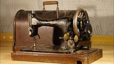 an old sewing machine sitting on top of a wooden table