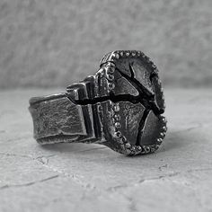 a silver ring sitting on top of a stone floor