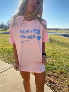 This is a Comfort Colors T-Shirt. The color of the shirt is blossom (light pink), with sky blue lettering. Sizes available as Small-Large. Fit is slightly oversized. Please message me with any questions! Chi Omega Sorority, Big Little Shirts, Sorority Merch, Sorority Tshirts, Brown Design, Alpha Chi Omega, Sorority Apparel, Alpha Chi, Sorority Outfits