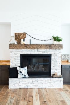 a living room with a fire place and wood flooring in front of the fireplace