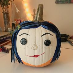 a pumpkin with a face painted on it