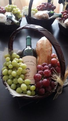 a table topped with baskets filled with grapes and cheese