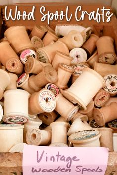 an old wooden box filled with lots of spools