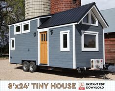 a tiny house is parked in front of a silo