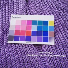 a purple knitted blanket with a color swat list on the front and back side