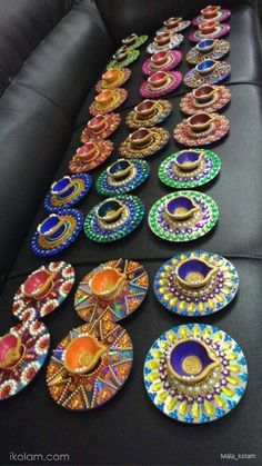 many colorful plates are arranged on a black couch