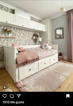 a white bed sitting in a bedroom on top of a hard wood floor next to a window