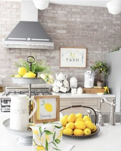 a bowl of lemons sitting on top of a kitchen counter