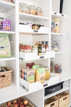 an organized pantry with lots of food in baskets on the shelves and other foodstuffs