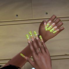 two hands with yellow and white nail designs on them