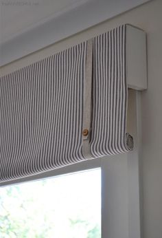 an image of a window with the blinds pulled up to open and showing how they are hanging