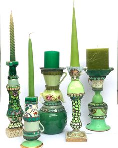 a group of vases and candles sitting on top of each other