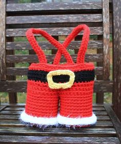 a crocheted red and black boot with santa claus's hat on it