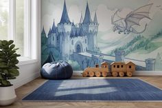 a child's room with a blue rug and castle mural on the wall behind it