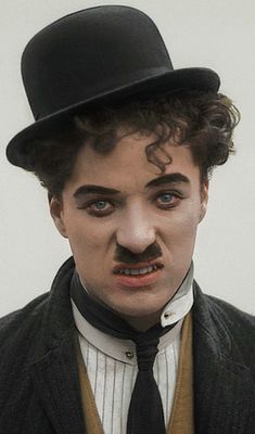 a man in a top hat and tie with fake mustaches on his face,