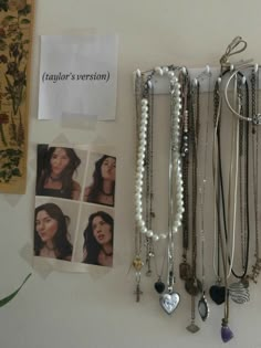 a bunch of necklaces hanging on a wall next to a sign that says taylor's version