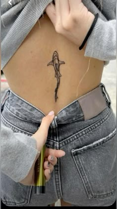 a woman with a small tattoo on her stomach