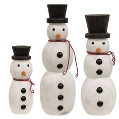 three snowmen with hats and ties on their heads are standing in front of each other