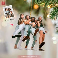 a group of young women hanging from a christmas ornament with the caption your photo