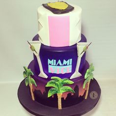 a cake that has been decorated with palm trees and the word miami on it,