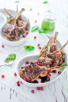 lamb chops with pomegranate and mint garnish in white bowls