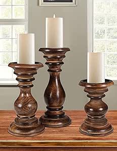 three wooden candlesticks sitting on top of a table