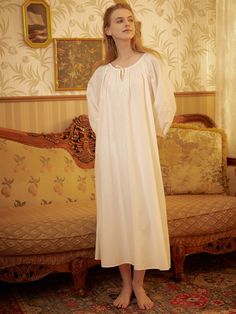 Immerse yourself in the embrace of 100% cotton with this Victorian-inspired women's nightgown. Revel in the soft, cloud-like comfort and feel stunning in its roomy and voluminous design. The well-constructed garment features clean lines, creating a breathable and anti-static experience. Three-quarter peasant sleeves with elastic cuffs are used to tolerate all body types. Embrace the cooling comfort of the elastic scoop neck design and enjoy the lovely, yet modest, outfit that allows unrestricted movement. This nightgown, reminiscent of the royal court style of the Victorian Edwardian era, transcends being just a garment; it's the essence of dreams. Washed in the highest quality cotton, it remains cool and feminine, providing a regal experience that makes you feel like a Victorian Princess. Victorian Woman Nightgown, Alicents Nightgown, Victorian Nightgown Romantic Cotton, Jane Eyre Nightgown, Victorian Flannel Nightgown, 1700s Nightgown, Woman In Nightgown, Medieval Nightgown, Granny Nightgown