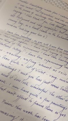 an old handwritten letter is laying on top of a piece of paper with blue ink