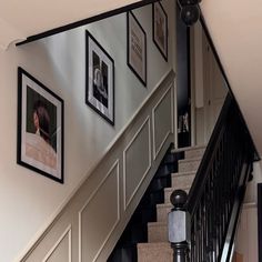 stairs with pictures on the wall above them