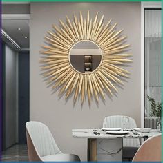 a dining room table with chairs and a mirror on the wall above it that has a gold starburst design