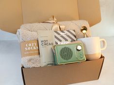 a box filled with coffee, books, and other items that are sitting on top of a table