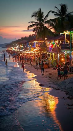 people are walking on the beach at night with colorful lights and palm trees in the background