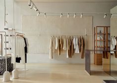 an open room with clothing hanging on clothes racks