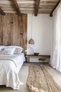 a bedroom with wood paneled walls and white bedding, rugs on the floor