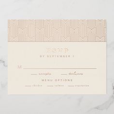 a white and gold wedding rsvp card on a marble surface with the word rsvp printed on it