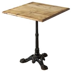 an old fashioned wooden table with black legs and a square top on a cast iron base