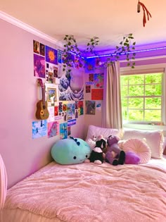 two stuffed animals sitting on top of a bed in a room with pink walls and curtains