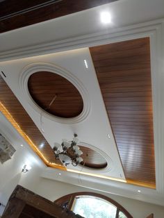 an overhead view of a living room with wood paneling and ceiling lights on the ceiling