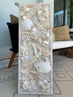 this is an art piece made out of seashells and other sea shells on the floor