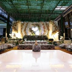 an indoor wedding venue with tables and chairs