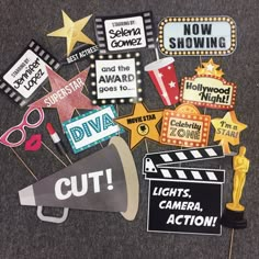 a bunch of signs that are on top of a table with some lights and camera action